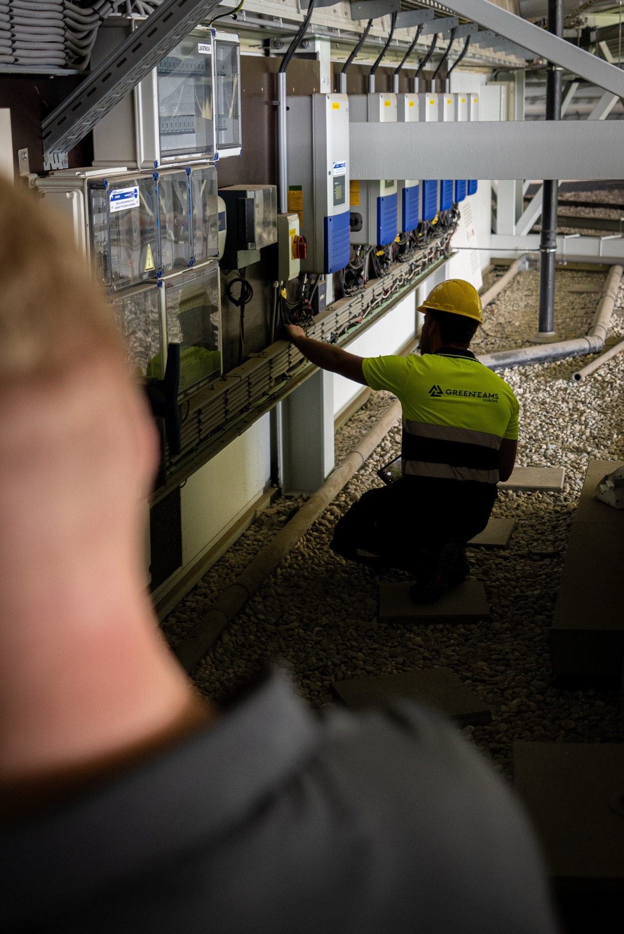 Engineer checking inverters on a solar site
