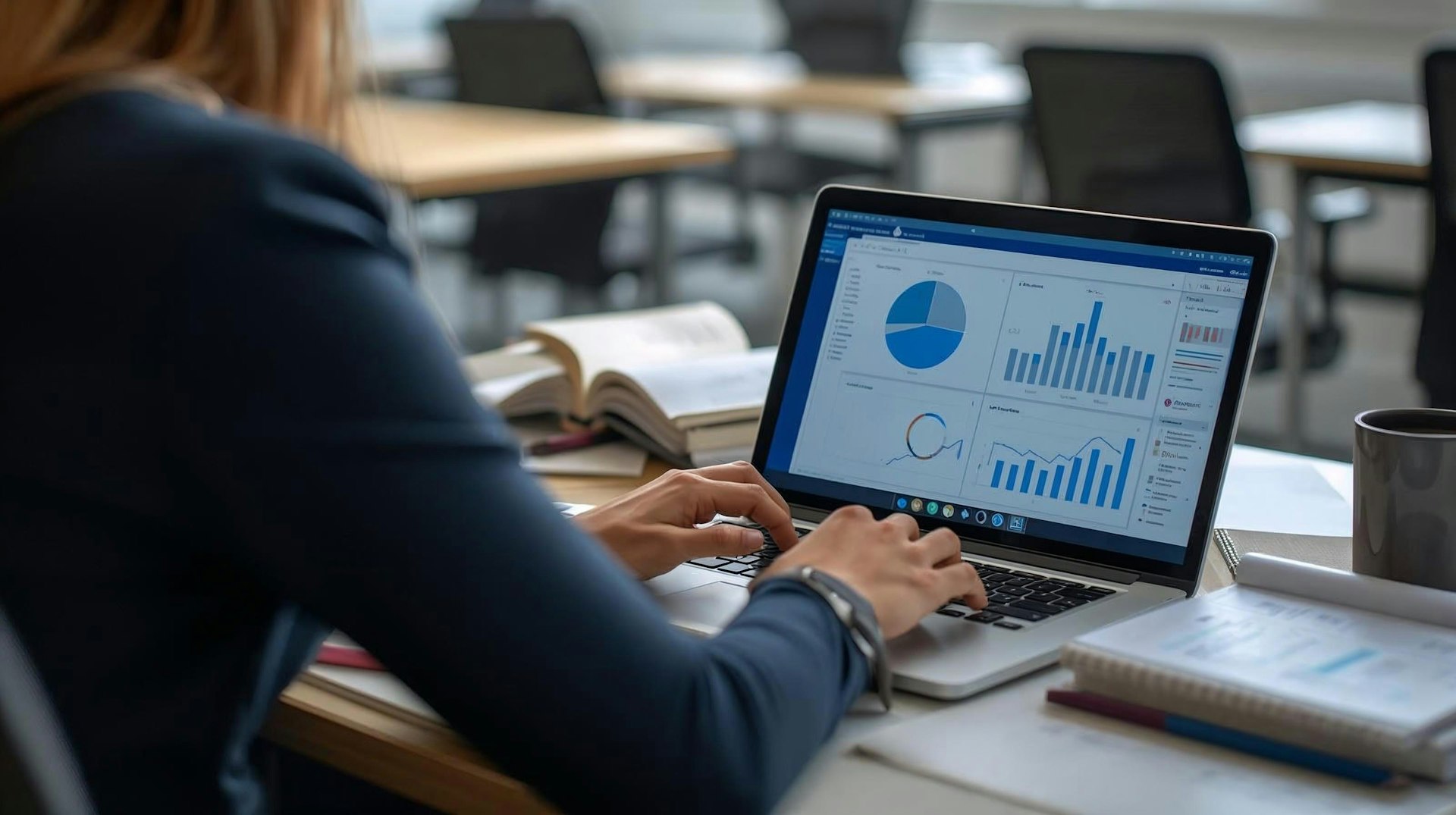 Financial dashboards and charts on a laptop at the office